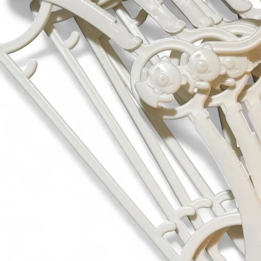 9 White plastic baby clothes hangers with bear design